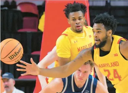  ?? KARL MERTON FERRON/BALTIMORE SUN ?? Maryland guard Jahari Long watches forward Donta Scott, right, steal the ball from Saint Peter’s guard Kyle Cardaci during the first half of Thursday night’s game in College Park.