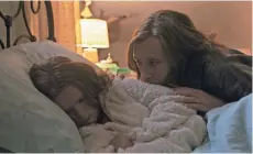 ?? A24 ?? Annie (Toni Collette) watches over her unnerving daughter, Charlie (Milly Shapiro), in “Hereditary.”
