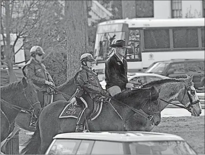  ?? [INTERIOR DEPARTMENT] ?? Newly minted Interior Secretary Ryan Zinke rides a horse owned by the U.S. Park Police to the Interior Department’s downtown Washington headquarte­rs on Thursday. There, during his first day at work, he pledged to devote more resources to national...