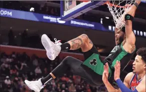  ?? Gregory Shamus / Getty Images ?? The Celtics’ Jayson Tatum dunks in front of the Pistons’ Cade Cunningham on Saturday.