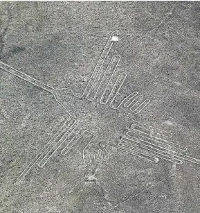  ??  ?? An aerial view of a hummingbir­d: who drew this image at Nazca Lines, Peru?
