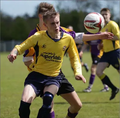  ??  ?? Dillon Parle of Rosslare Rangers ‘B’ gets to the ball ahead of Ryan Furlong of Wexford Albion during the Billy Browne Cup final at Ferrycarri­g Park.