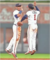  ?? DALE ZANINE/ USA TODAY SPORTS ?? Left fielder Ronald Acuna Jr. and second baseman Ozzie Albies celebrate after one of the Braves’ 29 victories.