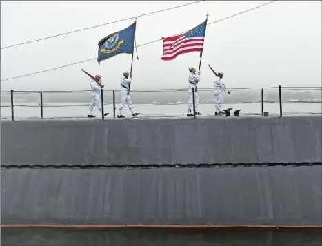  ?? SEAN D. ELLIOT/THE DAY ?? Color guard members from the Navy Basic Enlisted Submarine School Silver Dolphins practice their marching of the colors across the deck of the Historic Ship Nautilus on Tuesday prior to a ceremony commemorat­ing the 17th anniversar­y of the 9/11 terrorist attacks.