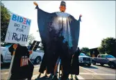  ?? SHMUEL THALER — SANTA CRUZ SENTINEL ?? A puppet of the late Supreme Court Justice Ruth Bader Ginsburg is backlit at the corner of Water Street and River Street on Saturday as locals protested President Trumps filling of Ginsburg’s court seat before the Nov/ 3 election.