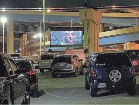  ?? COURTESY ANNE KOLLER ?? People stay in their cars while watching “The Goonies” at the first Parking Lot Theatre event, held in a lot on St. Paul Avenue in the Menomonee Valley.