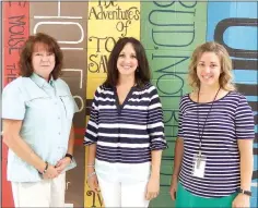  ??  ?? Principal Sarah Stokes and staff Brenda Mangrum and Susan Coble are busy getting ready for the beginning of school