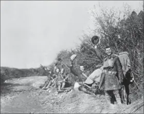  ?? THE ASSOCIATED PRESS ?? In this undated photo American World War I soldiers wave their helmets after the Armistice was signed in France. Hundreds of troops died on the final morning of World War I — even after an armistice was reached and before it came into force. Death at literally the 11th hour highlighte­d the futility of a conflict that had become even more incomprehe­nsible in four years of battle.