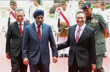  ??  ?? Good ties: Hishammudd­in and Harjit inspecting a guard-of-honour at the Defence Ministry in Kuala Lumpur.