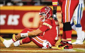  ?? DAVID EULITT / GETTY IMAGES ?? Chiefs quarterbac­k Patrick Mahomes holds his left ankle after being hit in the third quarter by the Colts on Sunday. “I think the lesson learned for me here tonight is that part of the Mahomes magic, a major part of it, is his ability to move,” NBC’s Cris Collinswor­th said.