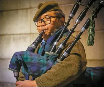  ?? Courtesy of Antonia Giordano ?? Daniel Kim plays bagpipes outside the fourth exhibition of The Hechyeomoy­eo in central Seoul’s East Atelier Gallery, Feb. 23.