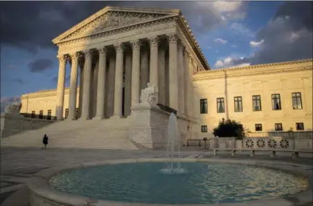  ?? J. SCOTT APPLEWHITE — THE ASSOCIATED PRESS ?? The Supreme Court in Washington is seen at sunset. In a 5-4 decision Friday, The Supreme Court says police generally need a search warrant if they want to track criminal suspects’ movements by collecting informatio­n about where they’ve used their cellphones.