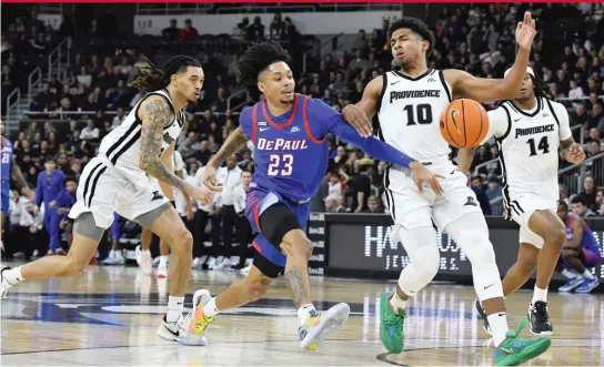  ?? MARK STOCKWELL/AP ?? DePaul guard Caleb Murphy reaches for the ball as Providence players close in during the first half Saturday in Providence, R.I.