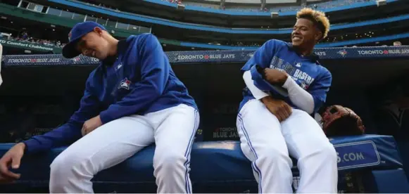  ?? STEVE RUSSELL/TORONTO STAR ?? Pitcher Marcus Stroman, right, catches up with Aaron Sanchez prior to Friday night’s game against the Orioles at the Rogers Centre. Stroman will start for the Bisons in Pawtucket on Monday.