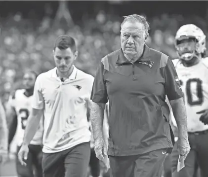  ?? DAVID BECKER/AP ?? Patriots head coach Bill Belichick walks off the field at the end of the first half against the Raiders on Sunday in Las Vegas.