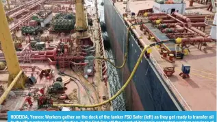  ?? AFP ?? HODEIDA, Yemen: Workers gather on the deck of the tanker FSO Safer (left) as they get ready to transfer oil to the UN purchased vessel Nautica, in the Red Sea off the coast of Yemen’s contested western province of Hodeida on July 24, 2023. —