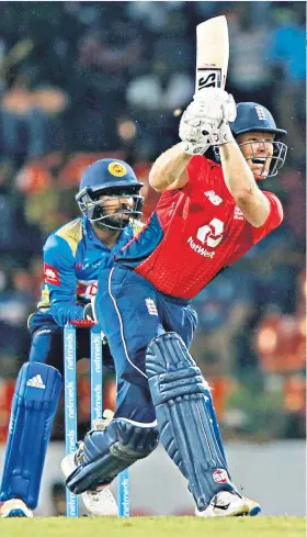  ??  ?? Complete performanc­e: Eoin Morgan hits out; Chris Woakes takes a catch (right)