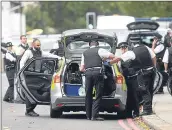  ??  ?? Armed police patrol the area around Exhibition Road, as the scene is cordoned off amid initial fears of another terror attack in the capital