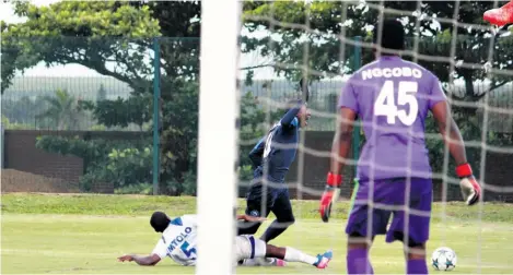  ??  ?? Mike Gumede is clearly brought down by Siphamandl­a Mtolo, who is far too late with his sliding challenge in the visitors’ penalty area…but the referee strangely books the NRB striker for diving