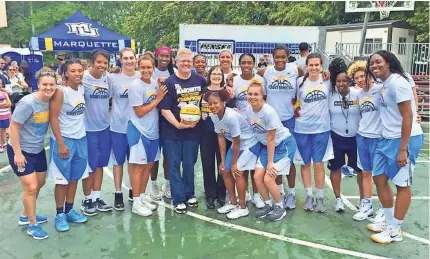  ?? See more photos at jsonline.com/news. PHOTO COURTESY OF JULIE TAGGART ?? The Marquette women’s basketball team put on a clinic at Summerfest this year, and faithful fans Julie and Tim Taggart grabbed a photo.