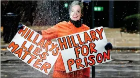  ?? REUTERS ?? A person wearing an orange jumpsuit and dressed as Hillary Clinton stands outside the venue of US Republican presidenti­al nominee Donald Trump’s campaign event in Manchester, New Hampshire, on Friday.