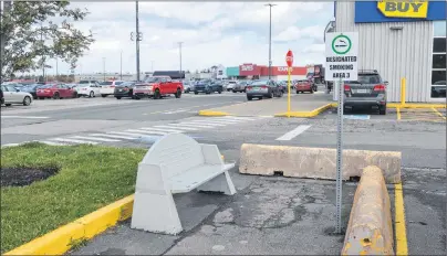  ?? DAVID JALA/CAPE BRETON POST ?? This is one of the three designated smoking areas at the Mayflower Mall. The shopping centre intends to strengthen the non-smoking regulation­s that apply to public places. People wishing to smoke, toke or vape while at the mall are required to be in one of the three zones that are located around the sprawling property.