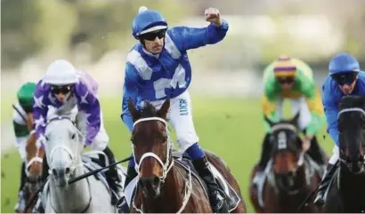  ?? Picture: Racing.com ?? . . . AND AGAIN: Jockey Hugh Bowman punches the air as he and supermare Winx cross the finishing line in the Winx Stakes at Randwick on Saturday.