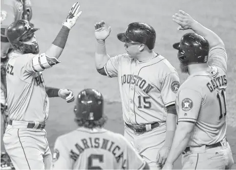  ?? Nick Wass photos / Associated Press ?? The Astros’ Marwin Gonzalez, left, celebrates his three-run home run with Carlos Beltran (15), Evan Gattis (11) and Jake Marisnick (6).