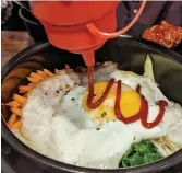  ?? ?? A Korean classic, Bibimbap with hot sauce.