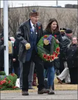 ?? ?? Second World War veteran John Watson and granddaugh­ter Jacey Fullerton walk towards the cenotaph to lay a wreath in honour of the unknown soldier.