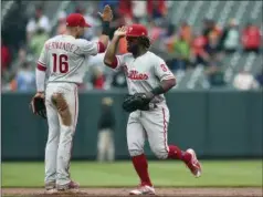  ?? GAIL BURTON — THE ASSOCIATED PRESS ?? The Phllies’ Cesar Hernandez, left, and Odubel Herrera celebrate their 4-1 win over the Orioles Wednesday in Baltimore.