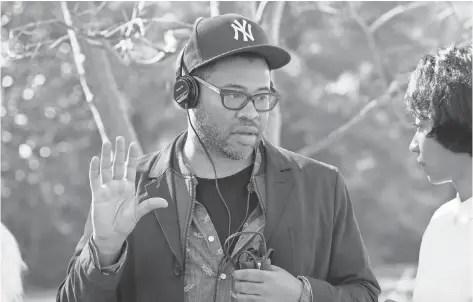  ?? PHOTOS BY JUSTIN LUBIN, UNIVERSAL PICTURES ?? Writer/ director/ producer Jordan Peele on the set of Get Out, which has topped $ 200 million worldwide at the box office.