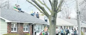  ?? BOB TYMCZYSZYN/POSTMEDIA FILE PHOTO ?? St. Patrick's Day celebratio­ns hit the roof last year in a Pen Centre area neighbourh­ood.