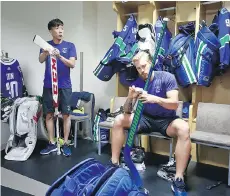  ??  ?? Goalie Zehao Sun, left, seen with the Canucks’ Anders Nilsson, is part of the nucleus of China’s national team program.