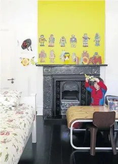  ??  ?? A BRIGHT YELLOW WALL IN NOAH’S BEDROOM IS PURE FUN. THE TABLE IS BY HALDANE MARTIN.