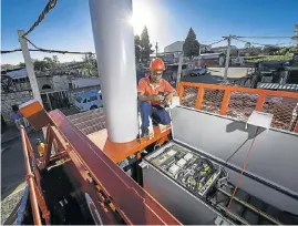  ?? Picture: SUPPLIED ?? HIGH SPEED: A technician checks on progress during installati­on of a Vodacom container base station in Alexandra, Johannesbu­rg, as township data use soars