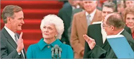  ?? / AP-file ?? President George H.W. Bush raises his right hand as he is sworn into office as the 41st president of the United States by Chief Justice William Rehnquist outside the west front of the Capitol as first lady Barbara Bush holds the bible for her husband on Jan. 20, 1989.