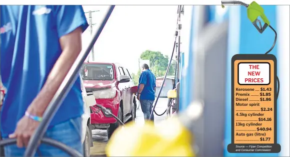  ?? Picture: JOVESA NAISUA ?? Bowser attendants fuel up vehicles in Suva yesterday. Government increased fuel and gas prices as of yesterday.