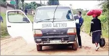  ?? ?? Some residents walk over 10km on the muddy road because public transport has not been operating at Mkhulamini. (R) A resident seen boarding a kombi after walking a long distance from home to be ferried to town.