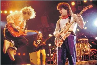  ?? PAUL NATKIN WireImage ?? THE ‘ VAN HAGAR’ ERA
The band Van Halen performs on March 15, 1986, in Chicago, with, from left, singer- guitarist Sammy Hagar, who replaced Roth; bassist Michael Anthony; and guitarist Eddie Van Halen.