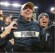  ?? MICHAEL HICKEY / GETTY IMAGES ?? Fans mob Purdue coach Jeff Brohm following his Boilermake­rs’ 49-20 upset victory Saturday night over Ohio State. Purdue has defeated the Buckeyes in five of the past eight games played at Ross-Ade Stadium in West Lafayette, Ind.