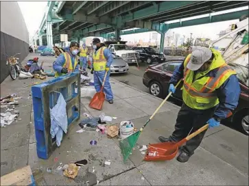  ?? Eric Risberg Associated Press ?? WORKERS clear away debris, including used syringes, from the remains of a tent city along Division Street in San Francisco in 2016. The city has long struggled with problems of human waste and needles on its streets.