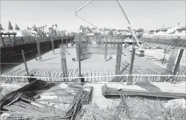  ??  ?? WORKERS DIG the foundation for a Hyatt Place hotel in San Gabriel. The prospect of uncertaint­y in U.S.China relations is rattling nerves as hotel projects across the San Gabriel Valley near completion.