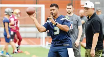  ?? AFP ?? Seattle Seahawks star quarterbac­k Russell Wilson (centre) has caught flak for his unofficial practices.