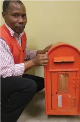  ??  ?? Postal assistant Johannes Job shows where the wooden pole was sawn through on the rescued box.