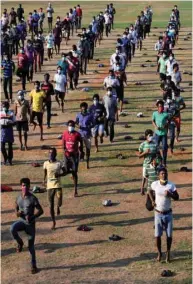  ??  ?? Migrant workers stranded due to a government-imposed nationwide lockdown as a preventive measure against the spread of the Covid-19, exercise at a shelter in Chennai yesterday.