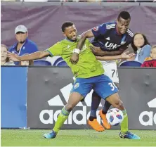  ?? StaFF FILe pHOtO by Stuart CaHILL ?? IN A TOUGH BATTLE: Cristian Penilla (left) and the Revolution take on the Portland Timbers in a key MLS matchup tonight at Gillette Stadium.