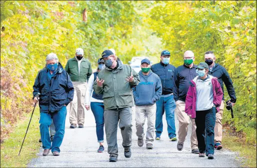  ?? ANDY LAVALLEY/POST-TRIBUNE PHOTOS ?? Moraine Nature Preserve property director Derek Nimetz, center, leads a short hike through grounds of the preserve grounds in Valparaiso on Thursday. New DNR director Dan Bortner is at left.