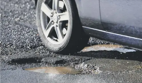  ?? PICTURE: JOE GIDDENS/PA ?? 0 Motorists are being urged to press their claims after their vehicles are damaged by potholes