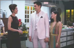  ?? The Associated Press ?? ROM-COM REVIVAL?: Michelle Yeoh, Henry Golding and Constance Wu in a scene from "Crazy Rich Asians," in theaters on August 17.